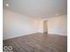 Large open living room area with recessed lighting and door to access other rooms at 6296 Wasco Dr, Whitestown, IN 46075
