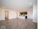 Spacious open-concept layout with modern kitchen, stainless steel appliances, and LVP flooring at 6296 Wasco Dr, Whitestown, IN 46075
