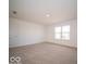 Spacious bedroom with neutral carpet and view to backyard at 6304 Wasco Dr, Whitestown, IN 46075