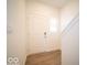 Bright entryway with wood-look floors, white door and trim, and a window for natural light at 6304 Wasco Dr, Whitestown, IN 46075