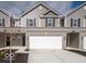 Charming townhome featuring a two-car garage, gray siding, black shutters and a concrete driveway at 6304 Wasco Dr, Whitestown, IN 46075