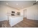 Bright kitchen features an island, stainless steel appliances, and wood-look flooring at 6304 Wasco Dr, Whitestown, IN 46075