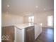 Kitchen island with stainless steel dishwasher and sink featuring an open concept layout at 6304 Wasco Dr, Whitestown, IN 46075