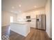 Open concept kitchen boasts stainless steel appliances, center island, and ample cabinet space at 6304 Wasco Dr, Whitestown, IN 46075