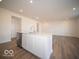 Kitchen island with sink and dishwasher in an open concept floor plan with wood-look floors at 6304 Wasco Dr, Whitestown, IN 46075