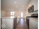Modern kitchen with island, stainless appliances, granite countertops and wood-look flooring at 6304 Wasco Dr, Whitestown, IN 46075