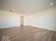 Large, light-filled living room with wood-look flooring and fresh white walls at 6304 Wasco Dr, Whitestown, IN 46075