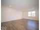 Bright and airy living room featuring wood-look flooring, white walls, and recessed lighting at 6304 Wasco Dr, Whitestown, IN 46075