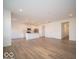 Spacious living room with wood-look flooring, white walls, flowing into the kitchen area at 6304 Wasco Dr, Whitestown, IN 46075