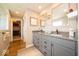 Bathroom featuring double sinks, a gray vanity, and a walk-in closet at 1220 Greenwood Station Blvd, Greenwood, IN 46143