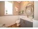 Powder room with decorative framed art, and vanity with a white quartz countertop at 1220 Greenwood Station Blvd, Greenwood, IN 46143