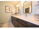 Modern bathroom featuring double sinks, decorative mirrors, and stylish fixtures at 1220 Greenwood Station Blvd, Greenwood, IN 46143