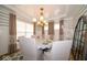 Dining room featuring striped walls, hardwood floors, and a large dining table set for dinner at 1220 Greenwood Station Blvd, Greenwood, IN 46143