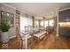 Bright dining room features a decorative mirror and an elegant dining table with bench seating and hardwood floors at 1220 Greenwood Station Blvd, Greenwood, IN 46143