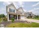 Well-manicured lawn leads up to this two-story home with brick and neutral colored siding at 1220 Greenwood Station Blvd, Greenwood, IN 46143
