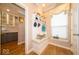 Mudroom offers a built-in bench and decorative shelving with a view of the pantry at 1220 Greenwood Station Blvd, Greenwood, IN 46143
