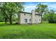 Large backyard with mature trees, green grass and back of house at 2747 E Midland Rd, Indianapolis, IN 46227