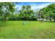 Over 1/2 acre yard with green grass, mature trees and swing set at 2747 E Midland Rd, Indianapolis, IN 46227