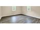 Neutrally painted bedroom featuring luxury vinyl plank flooring and large windows for natural light at 2747 E Midland Rd, Indianapolis, IN 46227