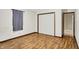 This empty bedroom features wood floors, a closet, and an entrance to another room at 2747 E Midland Rd, Indianapolis, IN 46227
