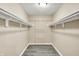 Walk-in closet with built-in shelving and luxury vinyl plank flooring providing ample storage space at 2747 E Midland Rd, Indianapolis, IN 46227