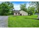 Traditional home surrounded by mature trees and lush greenery, providing a serene setting at 2747 E Midland Rd, Indianapolis, IN 46227