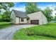 Lovely home with an attached garage, complemented by a verdant lawn and blue skies above at 2747 E Midland Rd, Indianapolis, IN 46227