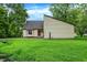 Charming home featuring well-maintained siding, manicured lawn, and a tranquil water feature at 2747 E Midland Rd, Indianapolis, IN 46227