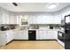 Open kitchen with white cabinets and black appliances at 2747 E Midland Rd, Indianapolis, IN 46227