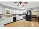 Kitchen with white cabinets, stainless sink, and black appliances at 2747 E Midland Rd, Indianapolis, IN 46227