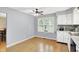 Bright eat-in kitchen with a ceiling fan, window, and white cabinets at 2747 E Midland Rd, Indianapolis, IN 46227