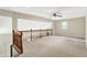 Large living room features a ceiling fan, natural lighting and wood banister overlooking the staircase at 2747 E Midland Rd, Indianapolis, IN 46227