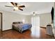 Spacious main bedroom featuring ceiling fans, hardwood floors, and natural light from a sliding door at 2747 E Midland Rd, Indianapolis, IN 46227