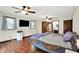 The primary bedroom features hardwood floors, multiple ceiling fans, and an ensuite bathroom at 2747 E Midland Rd, Indianapolis, IN 46227