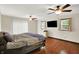 View of main bedroom shows two ceiling fans, dark wood floors, and a TV on the wall at 2747 E Midland Rd, Indianapolis, IN 46227