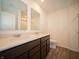 Bathroom featuring dual sinks, modern fixtures, and wood-look flooring at 6314 Wasco Dr, Whitestown, IN 46075