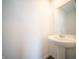 Powder room with pedestal sink and light colored walls at 6314 Wasco Dr, Whitestown, IN 46075