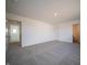 Empty bedroom with carpet, white walls, and doorway to the bathroom at 6314 Wasco Dr, Whitestown, IN 46075