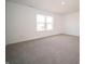 Empty bedroom with carpet and window overlooking the neighborhood at 6314 Wasco Dr, Whitestown, IN 46075