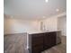 View of kitchen island overlooking dining area with dark cabinets and sink at 6314 Wasco Dr, Whitestown, IN 46075