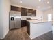 Modern kitchen with stainless steel appliances, dark cabinets, and white countertop island at 6314 Wasco Dr, Whitestown, IN 46075
