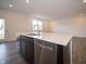 Kitchen island with stainless steel dishwasher, sink, and faucet overlooking dining area at 6314 Wasco Dr, Whitestown, IN 46075