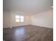 Spacious living room with neutral walls, hard surface flooring and large window at 6314 Wasco Dr, Whitestown, IN 46075