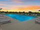 Community pool with lounge chairs at sunset with a colorful sky at 6314 Wasco Dr, Whitestown, IN 46075