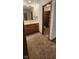 Bathroom vanity with wood cabinets, neutral countertop, and decorative mirror at 8855 N Waverly Park Rd, Martinsville, IN 46151