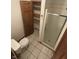 Compact bathroom featuring a shower stall and a toilet and a closet space with wooden shelves at 8855 N Waverly Park Rd, Martinsville, IN 46151