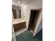 Bathroom showcasing a sink with cabinetry, a large mirror, and an entrance to the adjacent toilet area at 8855 N Waverly Park Rd, Martinsville, IN 46151