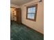 Bedroom with green carpet featuring closet space and natural light from the window at 8855 N Waverly Park Rd, Martinsville, IN 46151
