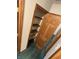 A closet with wooden trim features shelves and a wooden door, showcasing functional storage space at 8855 N Waverly Park Rd, Martinsville, IN 46151