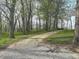 Gravel driveway amidst a wooded area, showcasing the property's secluded location at 8855 N Waverly Park Rd, Martinsville, IN 46151